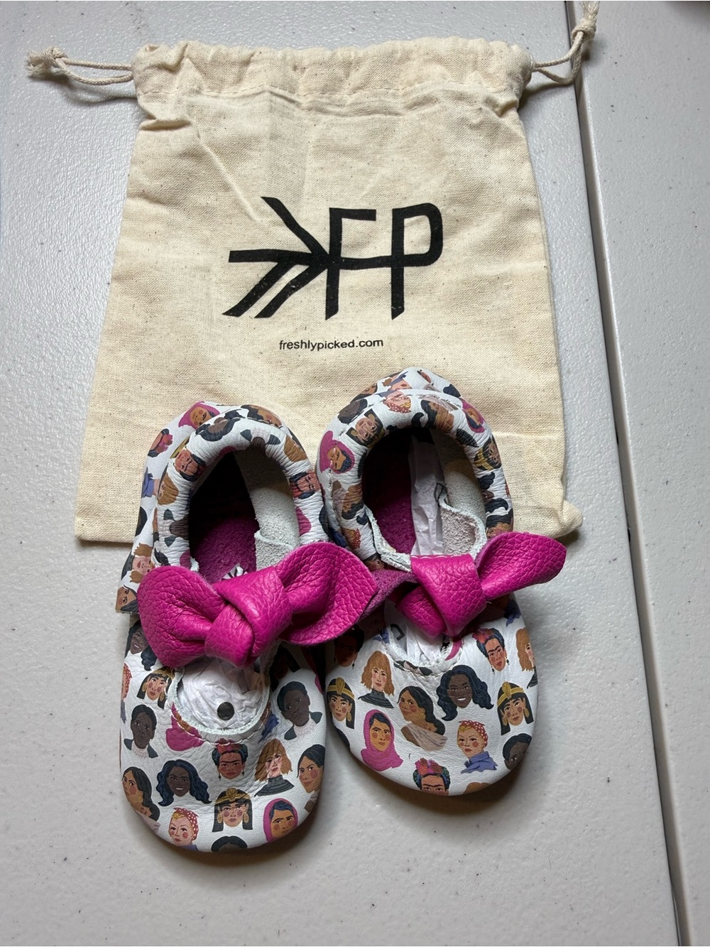 Freshly Picked Hot Pink Bow Moccasins with Diverse Faces Print